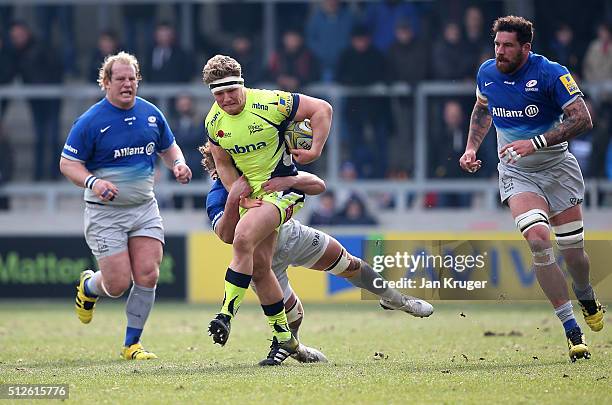 Ross Harrison of Sale Sharks is tackled by Jacques Burger of Saracens during the Aviva Premiership match between Sale Sharks and Saracens at AJ Bell...
