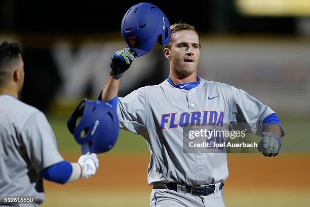Peter Alonso of the Florida Gators crosses home plate after hitting a two run home run against the Miami Hurricanes on February 26, 2016 at Alex...