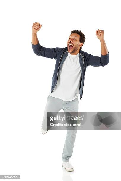 successful african man celebrating his achievement - cheering stock pictures, royalty-free photos & images