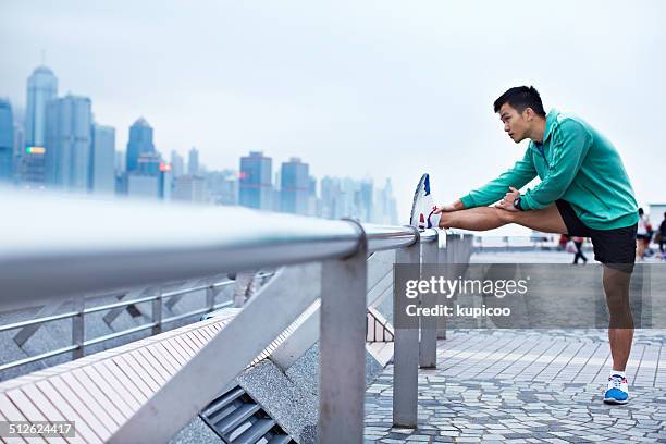 running through the urban jungle - warm up exercise asian stock pictures, royalty-free photos & images