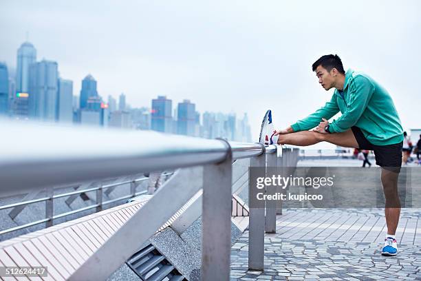 running through the urban jungle - asian man exercise stock pictures, royalty-free photos & images