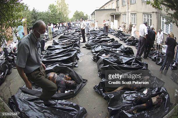 Russian relatives attempt to identify bodies of 330 known dead, the day after the three-day Russian school siege in Beslan, in which Chechen...