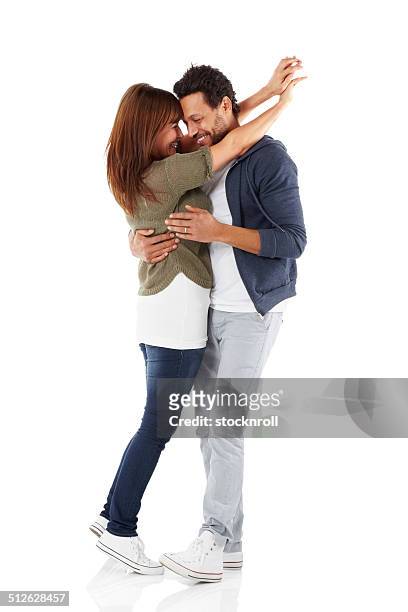 portrait of romantic mixed race couple embracing - couple studio shot stock pictures, royalty-free photos & images