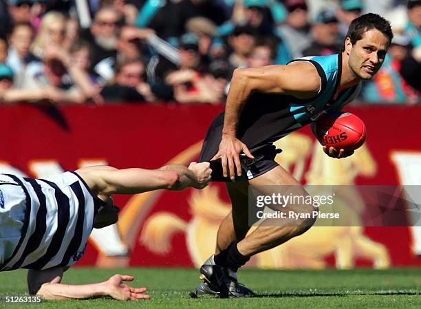 Gavin Wanganeen for the Power is tackled by his Cats opponent during the AFL First Qualifying Final match between The Port Adelaide Power and the...