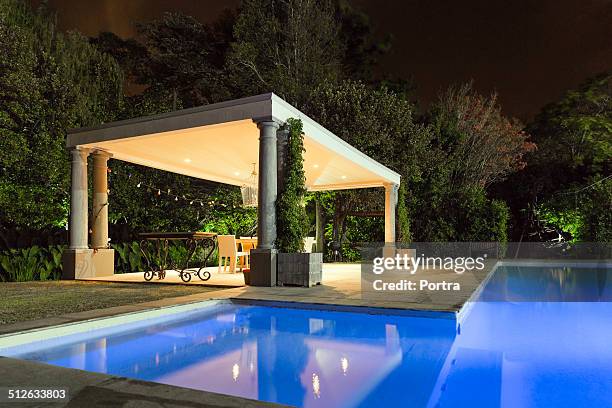 illuminated gazebo at poolside - gazebo stock pictures, royalty-free photos & images