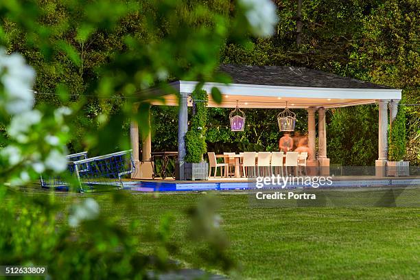 illuminated gazebo at poolside - gazebo stock pictures, royalty-free photos & images