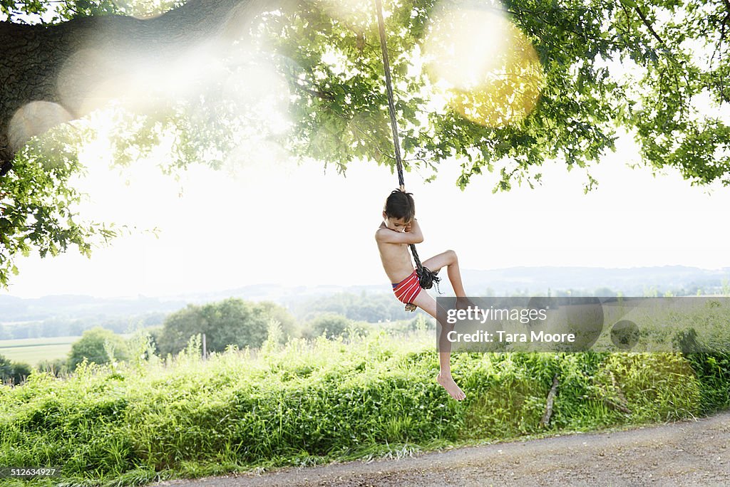 Boy swinging on rope