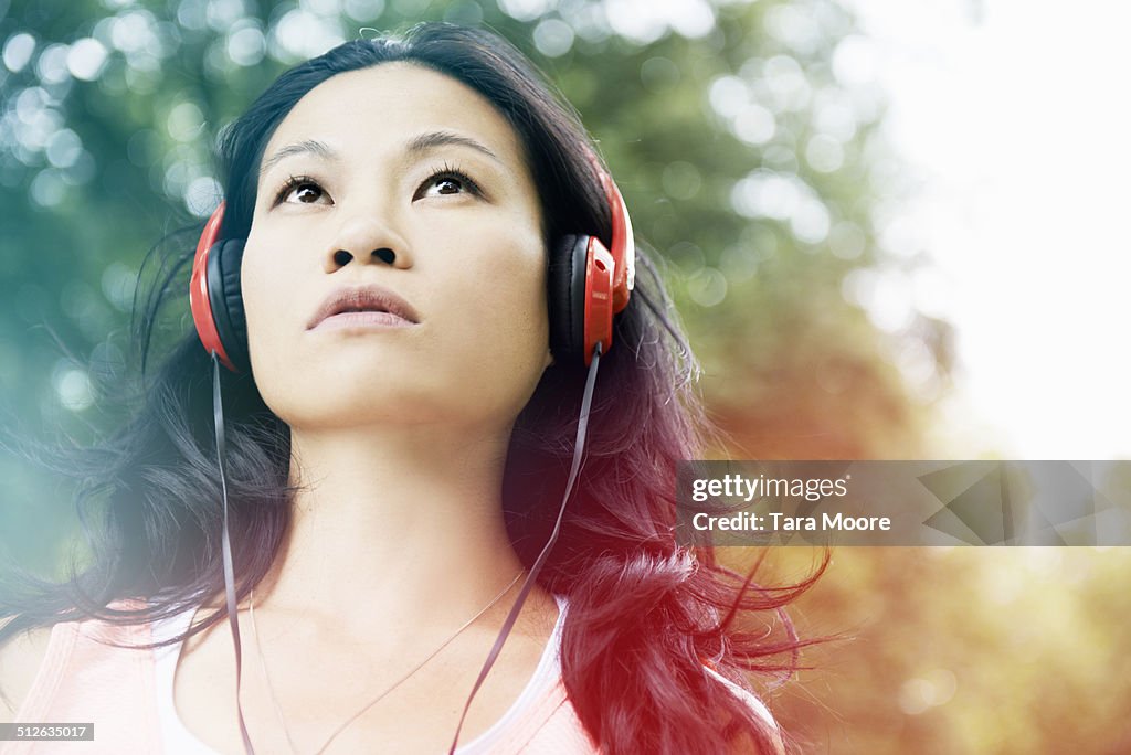 Woman wearing headphones in park