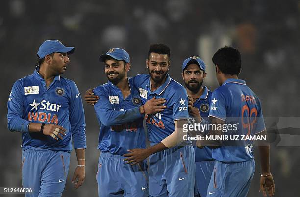 Indian cricketers congratulate teammate Hardik Pandya after the dismissal of the Pakistan cricketer Mohammad Amir during the match between India and...