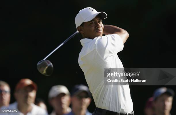 Tiger Woods hits a tee shot on the 7th hole during the third round of the Deutsche Bank Championship at the TPC of Boston on September 5, 2004 in...