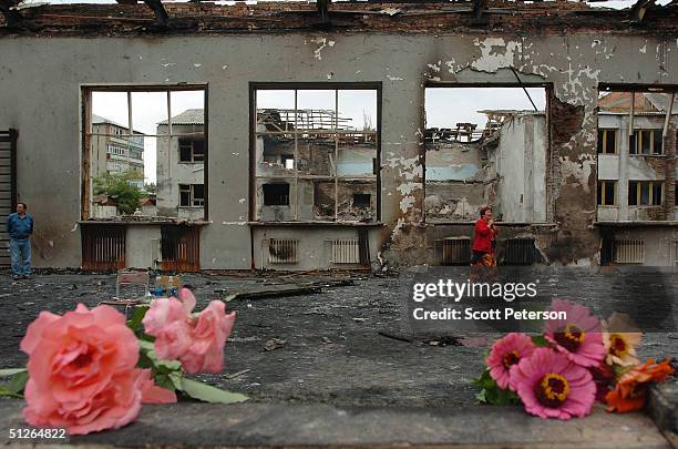 Friends and relatives left flowers at the ruins of the destroyed school, where more than 350 people were killed during a hostage situation on...