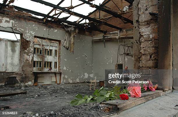 Friends and relatives left flowers in the ruins of the destroyed school, where more than 350 people were killed during a hostage situation on...