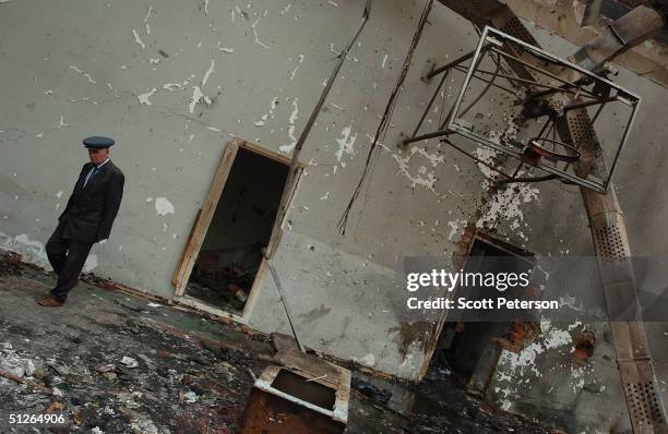 Friends and relatives visit the ruins of the destroyed school, where more than 350 people were killed during a hostage situation on September 5, 2004...