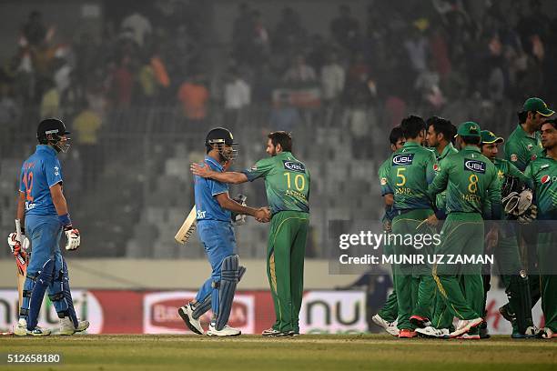 Pakistan's captain Shahid Afridi congratulates India's captain Mahendra Singh Dhoni at the end of the Asia Cup T20 cricket tournament match between...