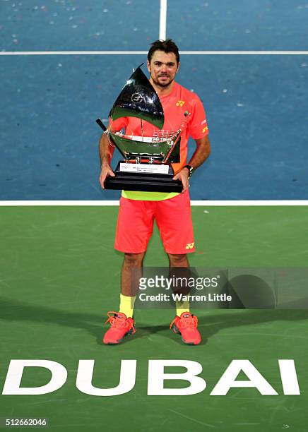Stan Wawrinka of Switzerland poses with the trophy after beating Marcos Baghdatis of Cyrus to win the ATP Dubai Duty Free Tennis Championship at the...
