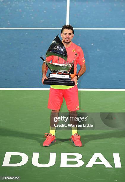 Stan Wawrinka of Switzerland poses with the trophy after beating Marcos Baghdatis of Cyrus to win the ATP Dubai Duty Free Tennis Championship at the...