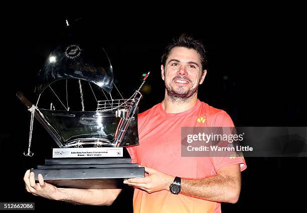 Stan Wawrinka of Switzerland poses with the trophy after beating Marcos Baghdatis of Cyrus to win the ATP Dubai Duty Free Tennis Championship at the...