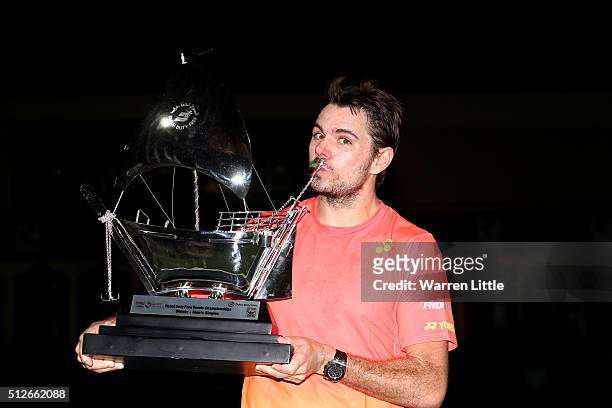 Stan Wawrinka of Switzerland poses with the trophy after beating Marcos Baghdatis of Cyrus to win the ATP Dubai Duty Free Tennis Championship at the...