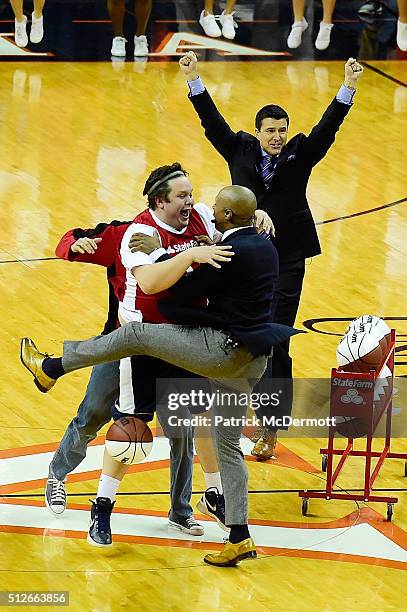 Andrew Board celebrates with ESPN College GameDay host Jay Williams after making a half-coart shot for $18,000 during a live broadcast of ESPN...