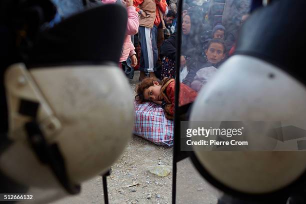 Refugees line up to cross the Greece-Macdonia border, outside a refugee camp which has become overcrowded as refugees continue to arrive from Athens...