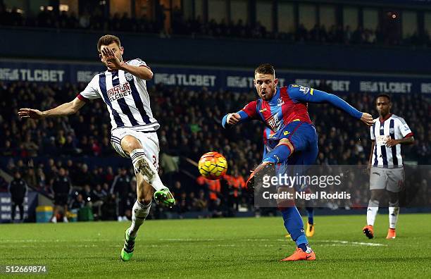 Connor Wickham of Crystal Palace shoots past Gareth McAuley of West Bromwich Albion to score their second goal during the Barclays Premier League...