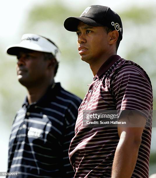 Vijay Singh of Fiji and Tiger Woods wait to hit their tee shots during the Deutsche Bank Championship on September 6, 2004 at the TPC of Boston in...