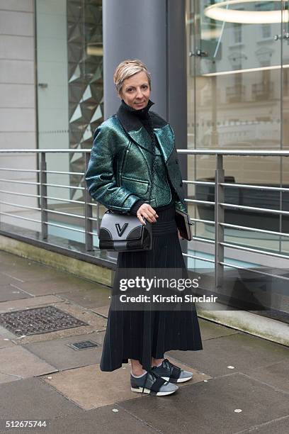 Elle magazine fashion director Anne Marie Curtis wears a Margaret Howell sweater, Carven jacket, Barbara Casasola skirt, Louis Vuitton bag and...