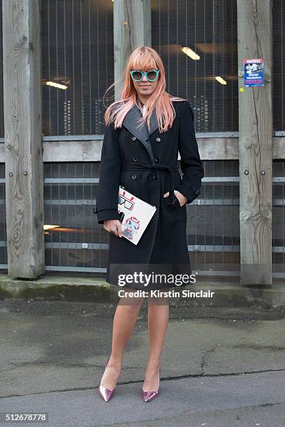 Model Amber Le Bon wears a Burberry coat, Karl Lagerfeld bag and Dior sunglasses on day 4 during London Fashion Week Autumn/Winter 2016/17 on...