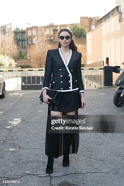 Model and Made in Chelsea star Emma Miller wears a Balmain jacket, Alexander McQueen skirt, Valentino bag, Alaia boots and Fendi sunglasses on day 4...