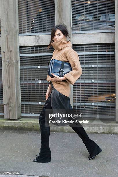 Fashion bogger Doina Ciobanu wears By Dimitri skirt and trousers, Paul Smith sweater, Christopher Kane bag and Gianvito Rossi boots on day 4 during...