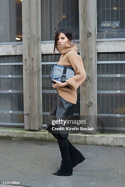 Fashion bogger Doina Ciobanu wears By Dimitri skirt and trousers, Paul Smith sweater, Christopher Kane bag and Gianvito Rossi boots on day 4 during...