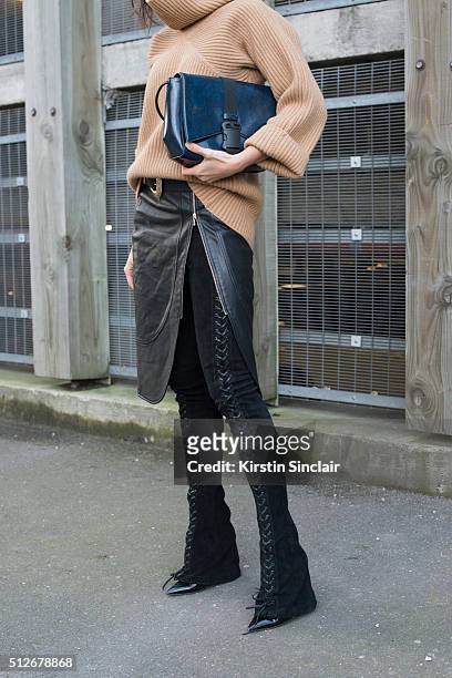 Fashion bogger Doina Ciobanu wears By Dimitri skirt and trousers, Paul Smith sweater, Christopher Kane bag and Gianvito Rossi boots on day 4 during...