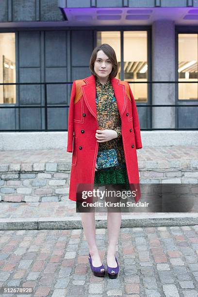 Model and Fashion blogger Ella Catliff wears a Coach dress, coat and bag, Robert Clergerie shoes on day 4 during London Fashion Week Autumn/Winter...