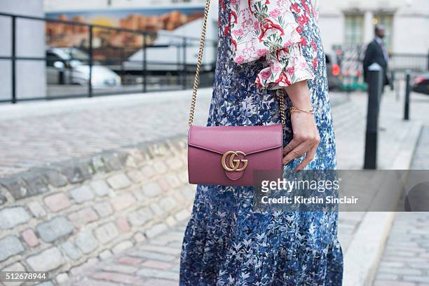Presenter Martha Ward Mother of Pearl dress and Gucci bag on day 4 during London Fashion Week Autumn/Winter 2016/17 on February 22, 2016 in London,...