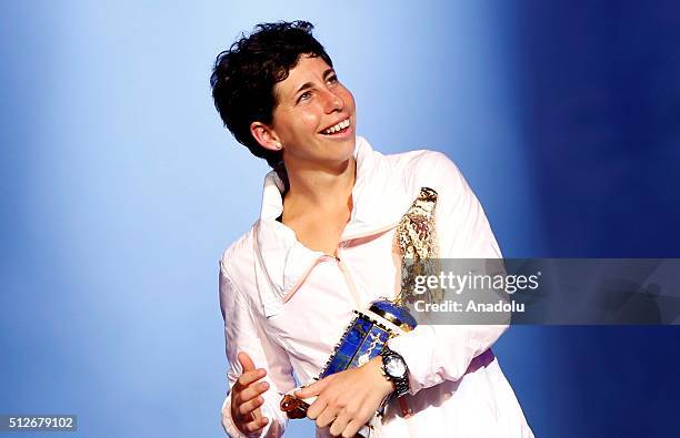 Carla Suarez Navarro of Spain poses with her trophy at the end of their Qatar Open final tennis match in Qatar, Doha on February 27, 2016.