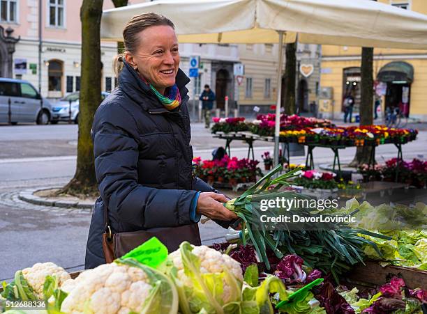 smiling woman at vegetable market in ljubljana, slovenia - lubiana stock pictures, royalty-free photos & images