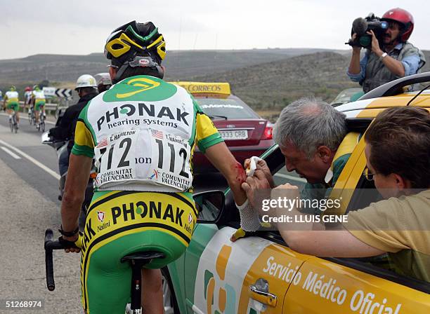 Tyler Hamilton of Phonak Hearing Systems is treated by doctors after being injured on his right leg and elbow during the 4th stage of the 59th Tour...