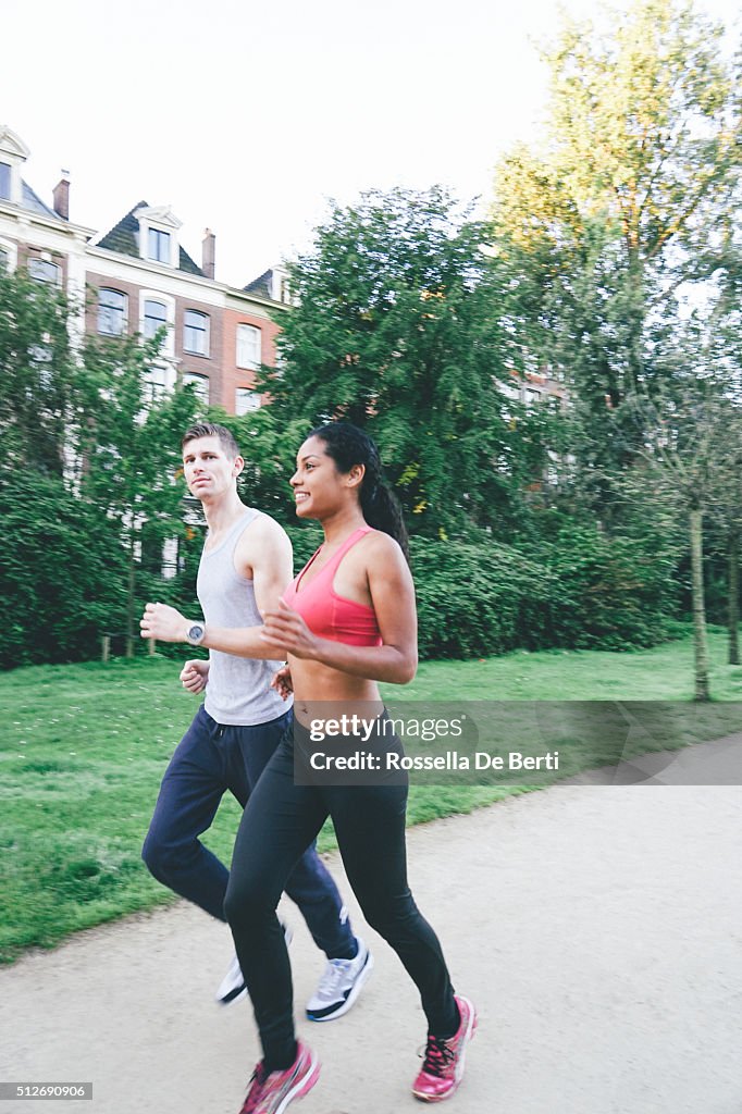 Cheerful Couple Running Outdoors In The Early Morning