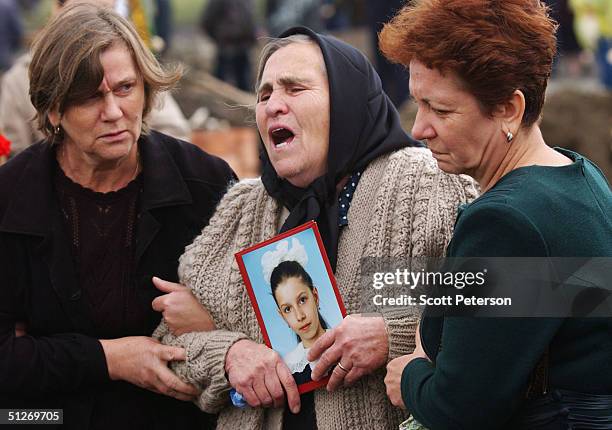 Relatives of those killed in the Beslan school massacre bury the dead for the third day September 7, 2004 in Beslan, Russia. The carnage began amid a...