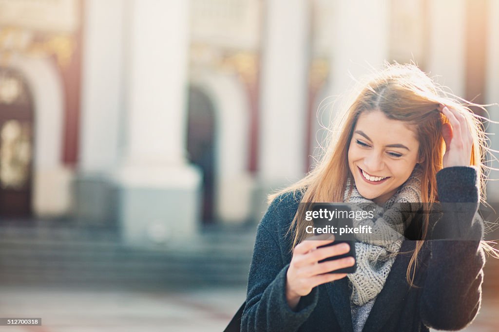 Smiling woman with a phone