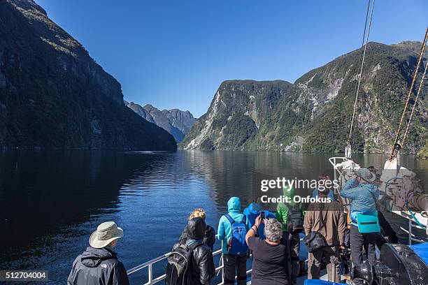 tourists group on a cruise at doubtful sound, new zealand - te anau stock pictures, royalty-free photos & images