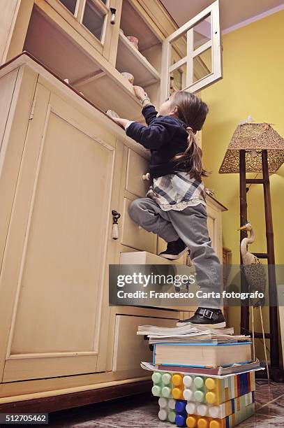 little girl climbing - vita domestica stock pictures, royalty-free photos & images