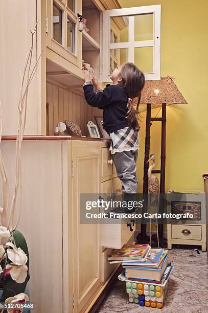 little girl climbing - vita domestica stock pictures, royalty-free photos & images