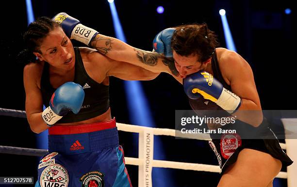 Cecilia Braekhus punshes Chris Namus during their Welterweight World Championship fight prior to the IBO Cruiserweight World Championship fight...