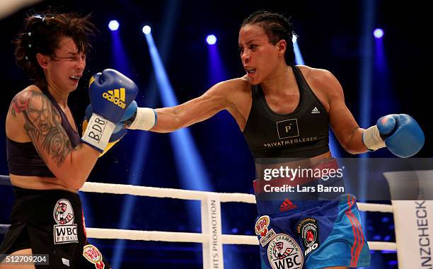 Cecilia Braekhus punshes Chris Namus during their Welterweight World Championship fight prior to the IBO Cruiserweight World Championship fight...