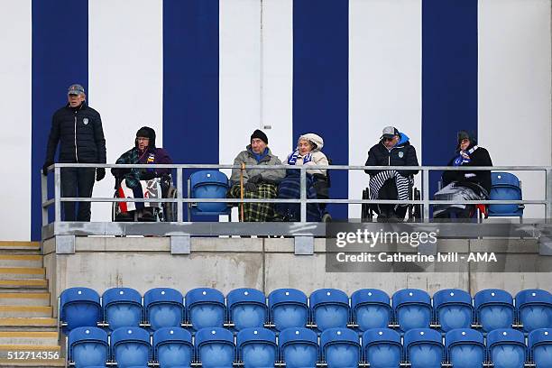 Disabled supporters sit infront of blue and white stripes during the Sky Bet League One match between Colchester United and Shrewsbury Town at the...