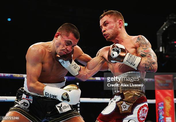 Carl Frampton connects with a punch on Scott Quigg during their World Super-Bantamweight title contest at Manchester Arena on February 27, 2016 in...