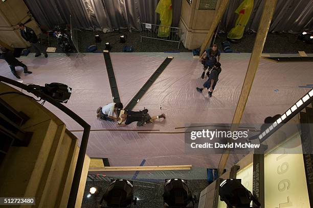Workers build sets in the court section of the Red carpet arrivals area that leads to the Dolby Theatre as preparations continue for the 88th Annual...