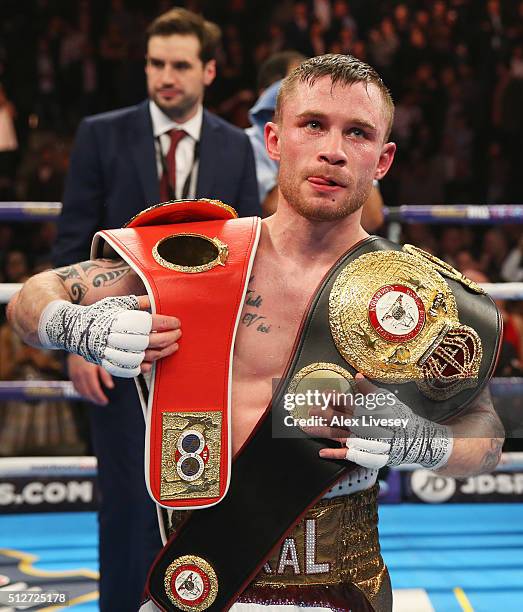Carl Frampton celebrates with belts after a points victory over Scott Quigg after their World Super-Bantamweight title contest at Manchester Arena on...