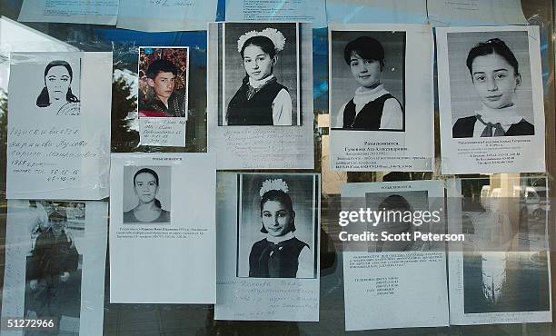 Portraits and lists of missing and dead children line the glass wall of the Palace of Culture September 8, 2004 in Beslan, southern Russia....